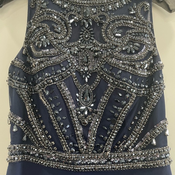 It’s a long dress with beautiful stones and it has long chiffon at the back